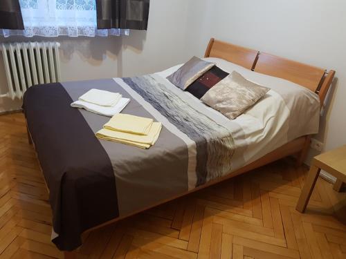 a bed with two towels on top of it at Apartment Gdańsk Wrzeszcz in Gdańsk