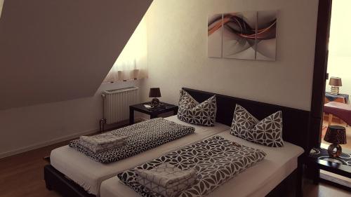 a bedroom with two beds and a painting on the wall at Gut Lauterbad Hotel in Freudenstadt