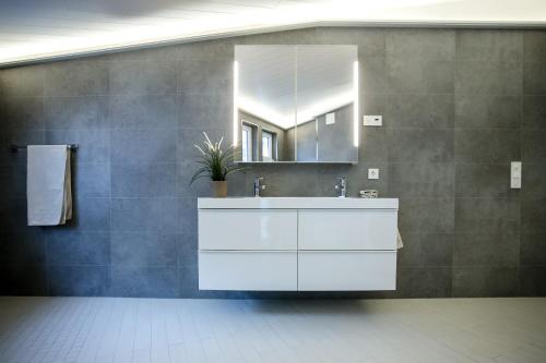 a bathroom with a white sink and a mirror at Floating House Bergen in Bergen