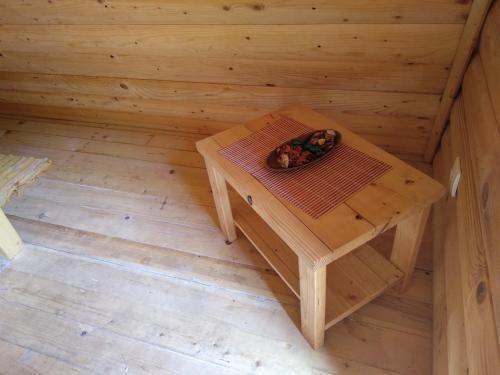 a small wooden table in the inside of a sauna at Camp Vrbas in Rekavice