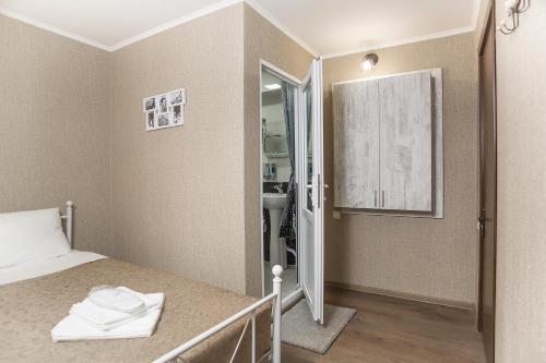 a small bedroom with a bed and a bathroom at Home25 in Tbilisi City