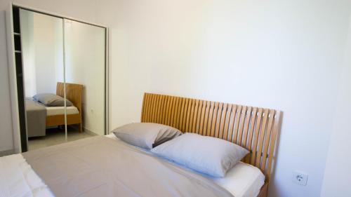 a bed in a room with a mirror at Vila Visnjic in Grebaštica