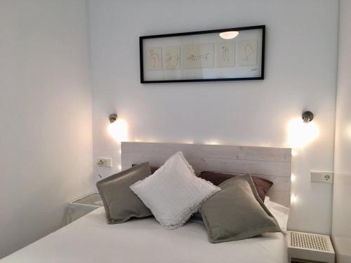 a bedroom with a bed with a mirror above it at Smart Studio Cadaqués Sa Guarda in Cadaqués