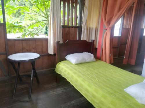A bed or beds in a room at Posada El Acuario