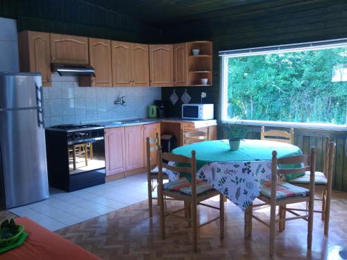 a kitchen with a table and chairs and a refrigerator at Holiday Home ZEN in Fažana