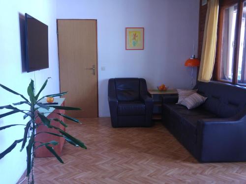 a living room with a couch and a chair at Holiday Home ZEN in Fažana