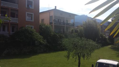 a green yard in front of a building at Eagle Rooms in Riva del Garda