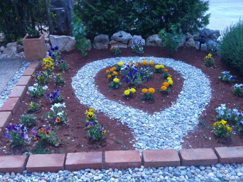 a garden with a flower arrangement in the ground at Holiday Home ZEN in Fažana