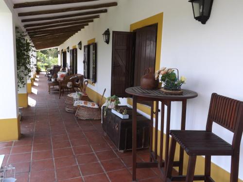 a porch of a house with chairs and tables at Quinta do Xarrama in Évora