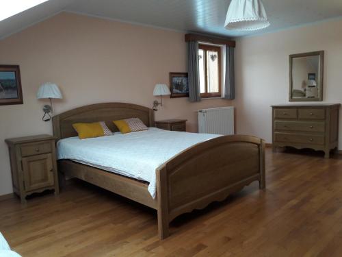 a bedroom with a large bed and two night stands at Traquebois in Fauvillers