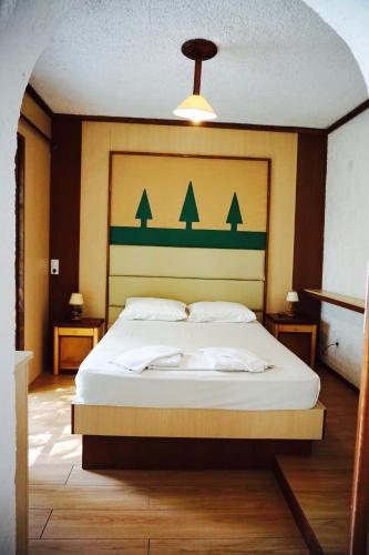 a bedroom with a large bed with a large headboard at Damnoni Paradise in Damnoni
