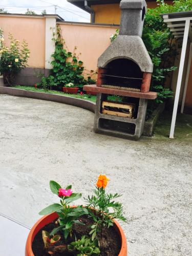 a garden with a flower pot and a fireplace at Apartment Irma in Sarajevo