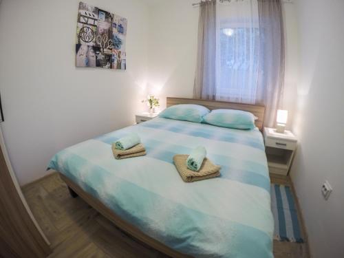 a bedroom with a bed with two towels on it at KUĆA ZA ODMOR NATALIJA in Pula