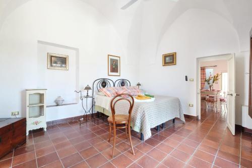 a bedroom with a bed and a table and chairs at Casa Nelly in Gallipoli