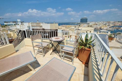 a balcony with chairs and a table and a city at Casa Nelly in Gallipoli