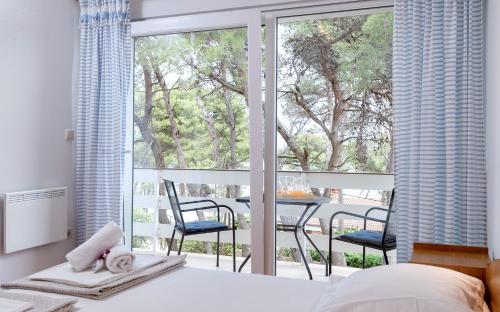 Postel nebo postele na pokoji v ubytování Apartmani Nivia