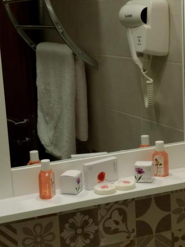 a bathroom with a mirror and a hair dryer at B&B Ponte Capograssi in Sulmona