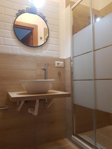 a bathroom with a sink and a mirror at Hercules House - Il riposo degli Eroi in Ercolano