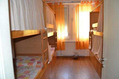 a room with two bunk beds and a window at Hostel Valentin 2 in Skopje