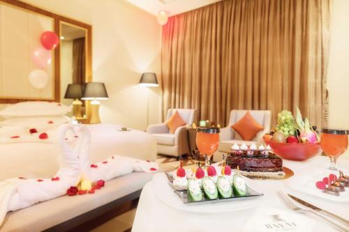 a hotel room with two beds and a table with food at Bayat Hotel in Khamis Mushayt