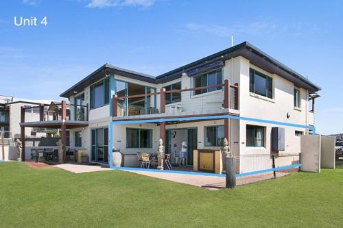 a large house with a lawn in front of it at White Waves on the Beach in Hastings Point