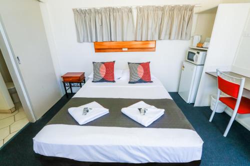 a hotel room with two beds and a kitchen at Miriam Vale Motel in Miriam Vale
