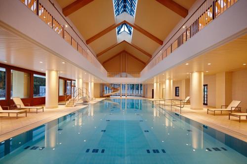 a large swimming pool with a large ceiling at Lotte Arai Resort in Myoko