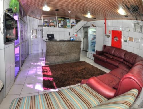 uma sala de estar com um sofá e um bar em Hotel Granada Concept em Manaus