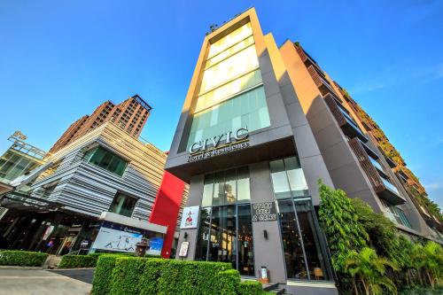 a building with a sign on the side of it at Civic Horizon Hotel & Residence in Bangkok