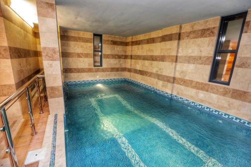 a large swimming pool in a room with at Raihana for serviced apartment in Jeddah