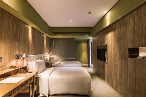 A bed or beds in a room at inhouse Hotel