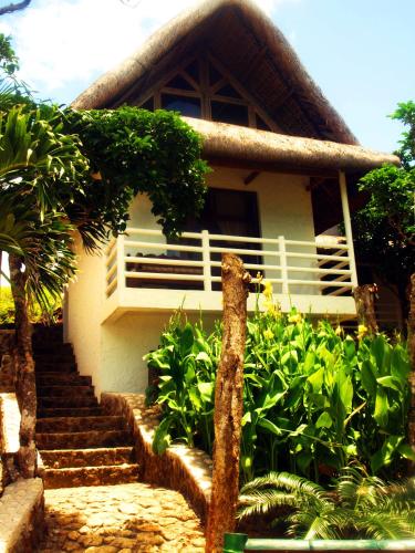 a house with stairs leading up to it at Alta Vista Ilocandia Inc. in Pagudpud