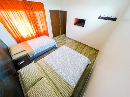 Postel nebo postele na pokoji v ubytování DC Suites Aeropuerto
