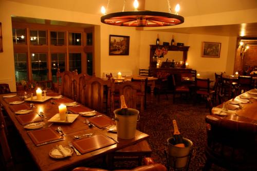 a dining room with a table with candles on it at Chequers Inn Hotel in Forest Row