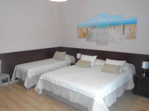 a room with two beds and a painting on the wall at BELLAVISTA B&b in Lamezia Terme