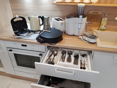 a kitchen counter with many appliances on it at HaPPy InnSide, Free Parking, Self check-in 7x24h, AC in Vilnius