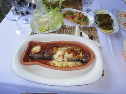 a white plate with a dish of food on a table at Portalimo Lodge Hotel - Adult Only +12 in Cıralı