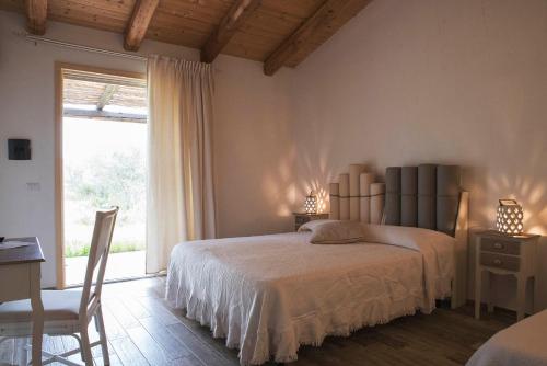 a bedroom with a bed and a window at Nacchinono in Olbia
