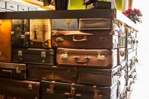 a stack of suitcases stacked on top of each other at Hotel Bardolino in Bardolino