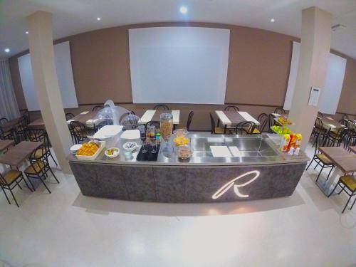 a buffet in a room with tables and chairs at Hotel Ricci in Rimini
