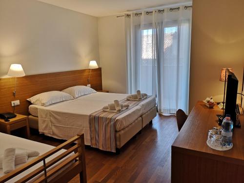 Postel nebo postele na pokoji v ubytování Lacroma Bio Hotel & Apartments