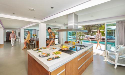 a kitchen with people walking around in a house at Casa India Ibiza in Santa Eularia des Riu