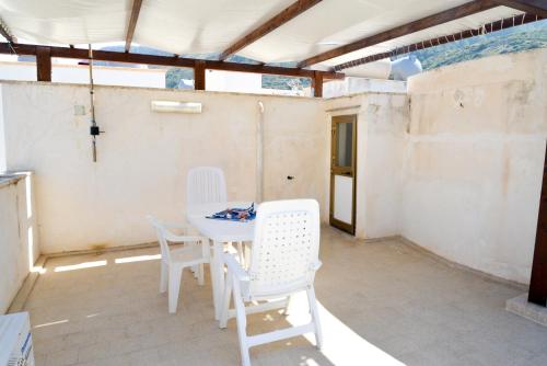 a white table and chairs on a patio at Casa Duran in Marettimo