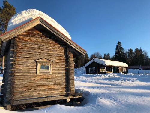 a log cabin in the snow with snow on it at Vasa Ski Lodge in Mora