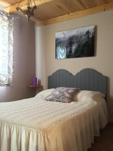 a bedroom with a bed with a pillow on it at GITE*** DES BARAQUES in Fontenoy-le-Château