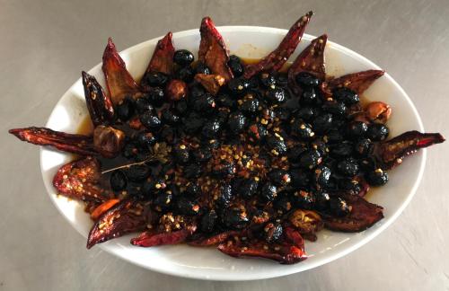 a plate of food with black olives and other foods at Agriturismo Miracco Atanasio Franco "Il Maniero" in Santa Sofia dʼEpiro