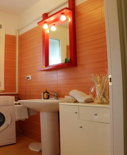 a bathroom with a sink and a mirror at Leuca Casa del Mare in centro in Leuca