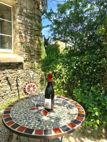 a bottle of wine sitting on a table with glasses at Glatigny Farmhouse - close to beach - proche de la plage in Glatigny
