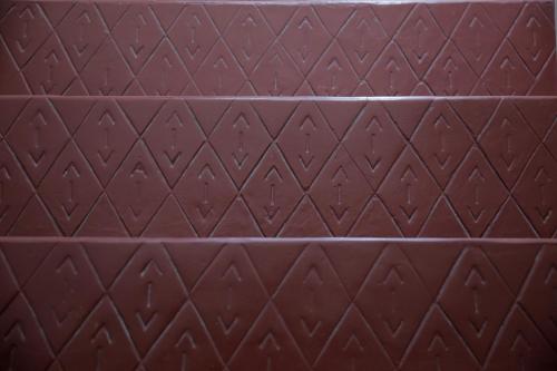 a close up of a brown leather surface with diamond patterns at Casa Malpique in Albufeira
