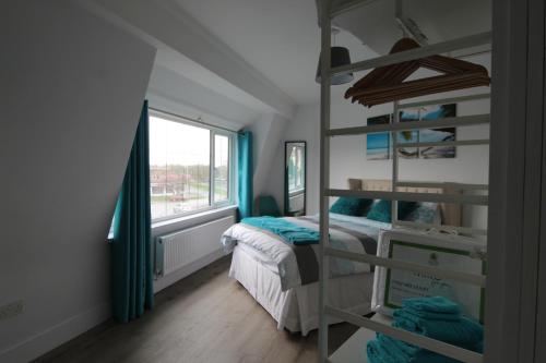 リバプールにある2 Serviced Apartments in Childwall-South Liverpool - Each Apartment Sleeps 6のベッドルーム(二段ベッド1組、窓付)